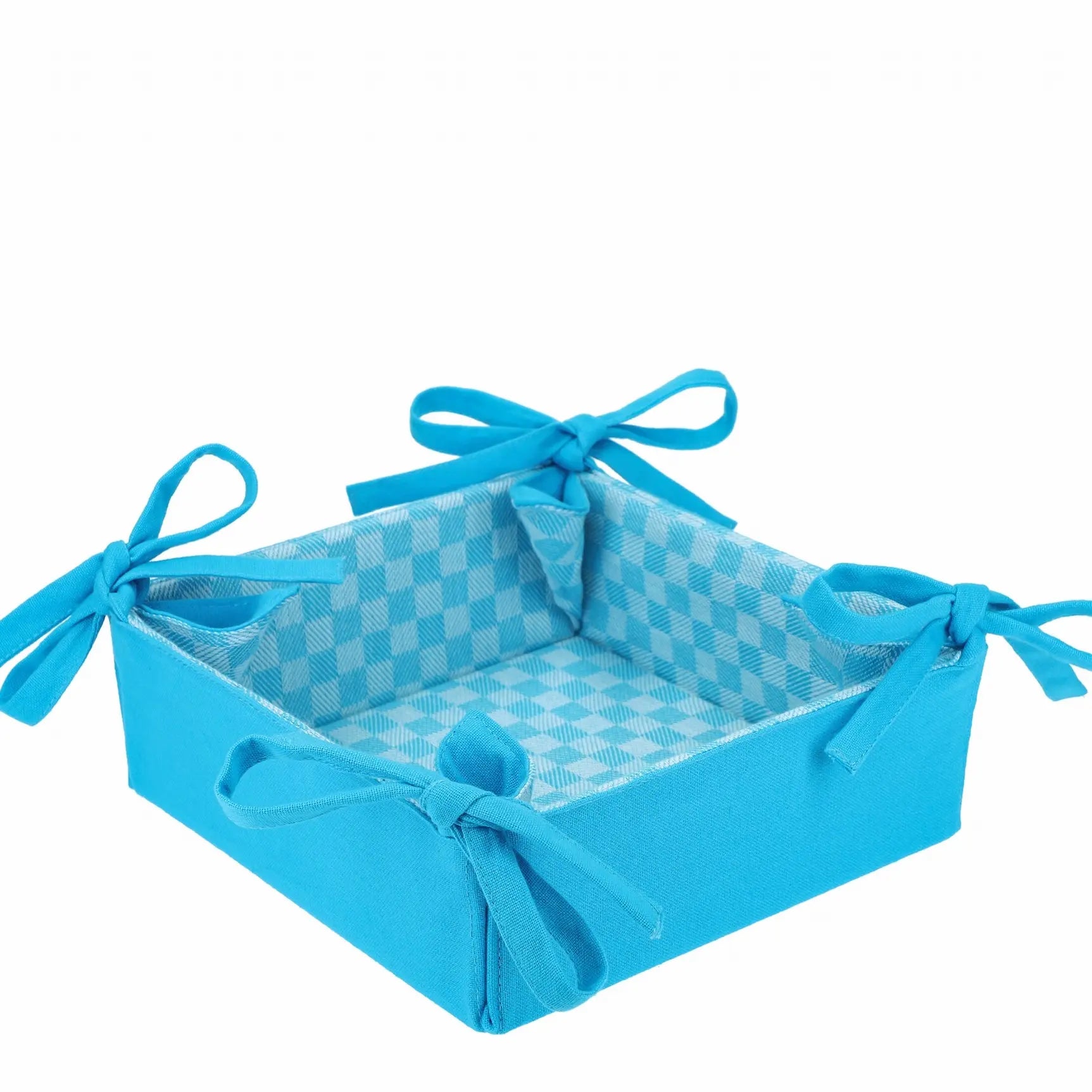 Corbeille en tissu à damier réversible bleue avec noeuds, idéale pour la présentation élégante de pain et fruits.
